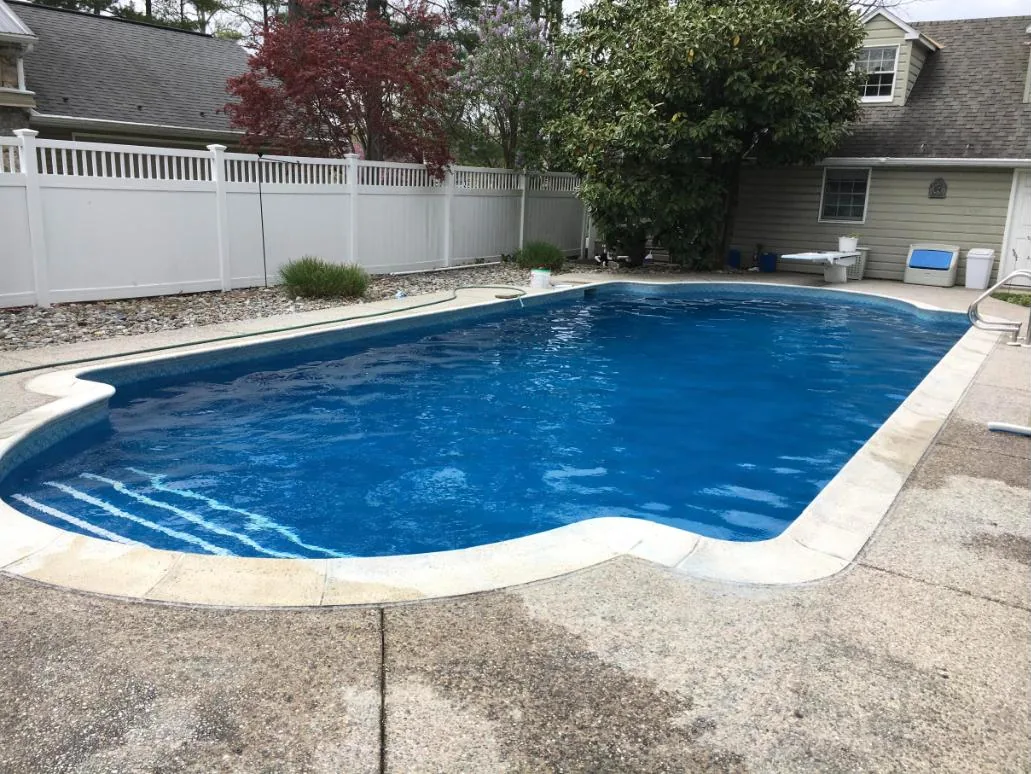 Rectangular pool with concrete coping and deck joints around the edge